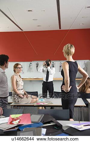 Designers examining dress in studio View Large Photo Image Picture - Designers examining dress in studio. Fotosearch