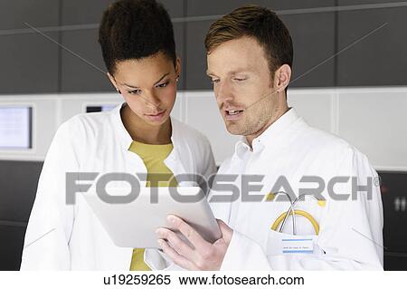 Stock Photography - Doctor and patient with tablet computer . Fotosearch