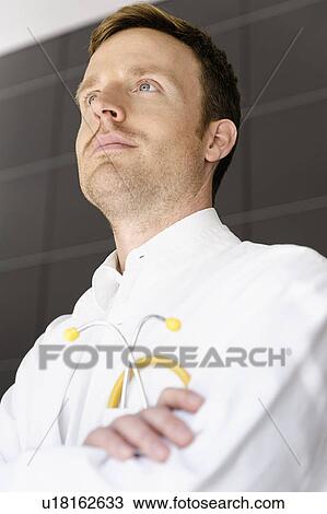 Stock Image - Doctor standing in hospital. Fotosearch