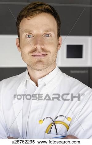 Doctor standing in hospital View Large Photo Image Stock Photography - Doctor standing in hospital. Fotosearch
