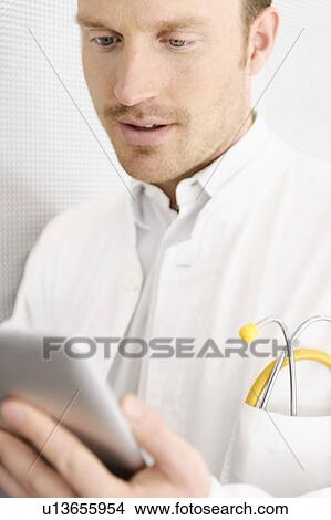 Picture - Doctor using tablet computer. Fotosearch