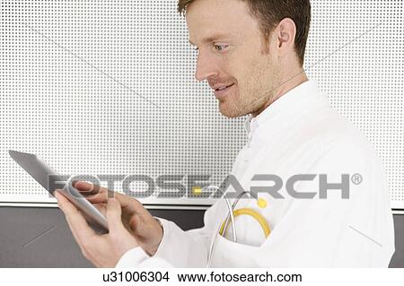 Picture - Doctor using tablet computer. Fotosearch