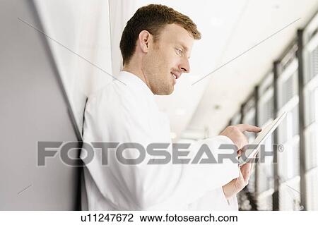 Doctor using tablet computer View Large Photo Image Stock Image - Doctor using tablet computer. Fotosearch