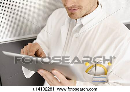 Doctor using tablet computer View Large Photo Image Stock Image - Doctor using tablet computer. Fotosearch