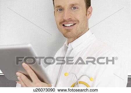 Doctor using tablet computer View Large Photo Image Stock Image - Doctor using tablet computer. Fotosearch