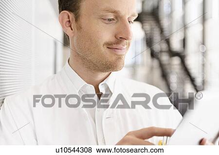 Stock Photo - Doctor using tablet computer. Fotosearch