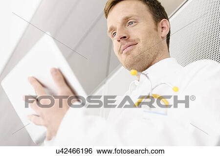 Doctor using tablet computer View Large Photo Image Stock Photograph - Doctor using tablet computer. Fotosearch