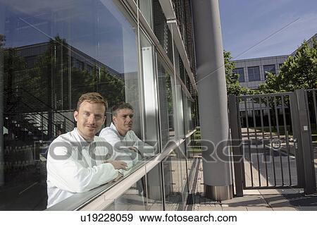 Stock Photo - Doctors standing at office window. Fotosearch
