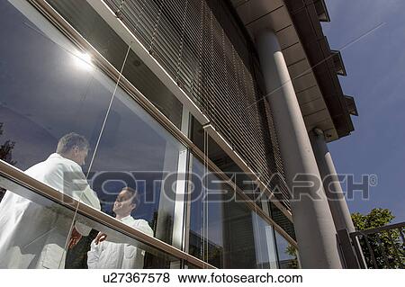 Doctors talking at office window View Large Photo Image Stock Photo - Doctors talking at office window. Fotosearch