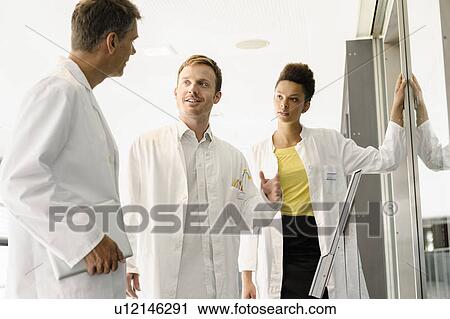 Doctors talking in hospital View Large Photo Image Stock Image - Doctors talking in hospital. Fotosearch