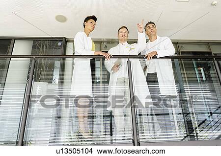 Picture - Doctors talking on balcony in hospital. Fotosearch