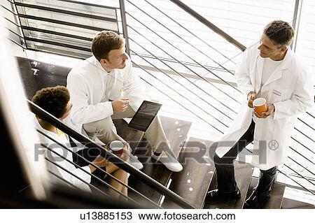 Doctors talking on steps in hospital View Large Photo Image Stock Image - Doctors talking on steps in hospital. Fotosearch