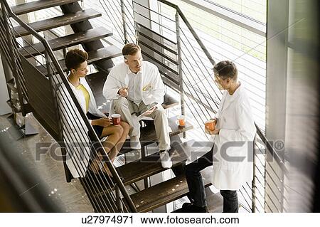 Doctors talking on steps in hospital View Large Photo Image Stock Image - Doctors talking on steps in hospital. Fotosearch