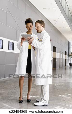 Doctors using tablet computer View Large Photo Image Stock Photo - Doctors using tablet computer . Fotosearch