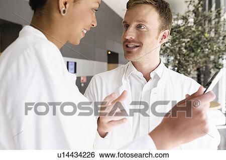 Doctors using tablet computer View Large Photo Image Stock Photograph - Doctors using tablet computer . Fotosearch