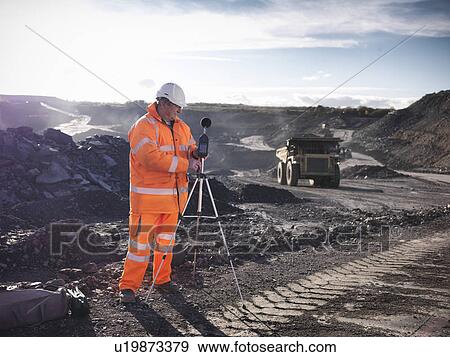 Stock Photo - Ecologist listening to coal mine. Fotosearch