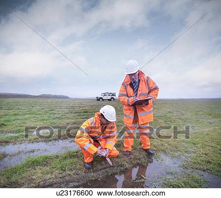Ecologists examining dirty pond View Large Photo Image Stock Image - Ecologists examining dirty pond. Fotosearch