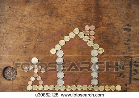 Euro coins in shape of house and person View Large Photo Image Stock Photo - Euro coins in shape of house and person. Fotosearch