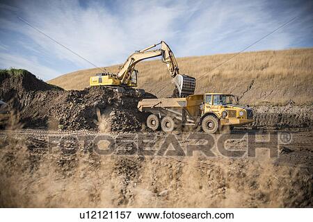 Stock Photo - Excavator working at surface coal mine. Fotosearch