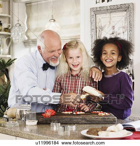 Family baking Christmas cookies together View Large Photo Image Picture - Family baking Christmas cookies together. Fotosearch