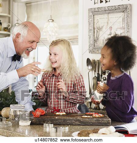 Family baking Christmas cookies together View Large Photo Image Stock Image - Family baking Christmas cookies together. Fotosearch
