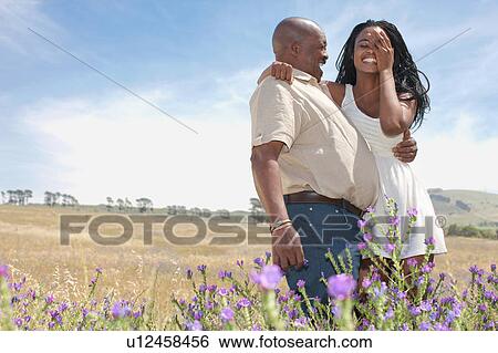 Stock Photograph - Father and daughter hugging outdoors. Fotosearch