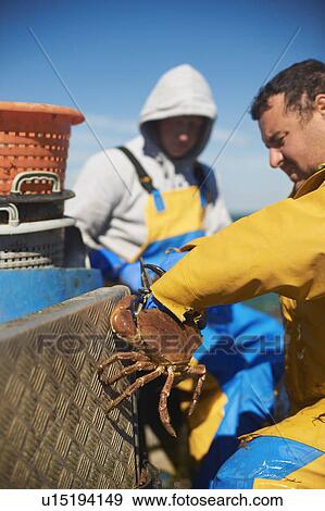 Stock Photo - Fisherman at work on boat. Fotosearch