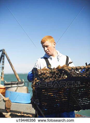 Fisherman at work on boat View Large Photo Image Stock Photograph - Fisherman at work on boat. Fotosearch