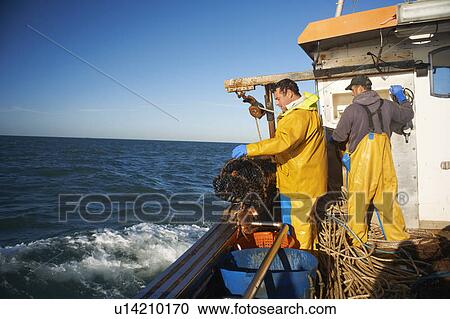Fishermen at work on boat View Large Photo Image Stock Image - Fishermen at work on boat. Fotosearch