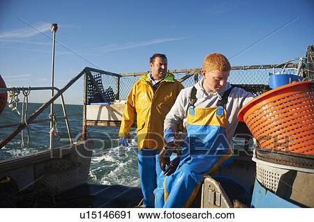 Fishermen at work on boat View Large Photo Image Stock Image - Fishermen at work on boat. Fotosearch