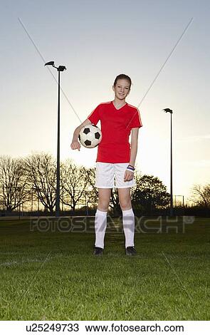 Football player standing with ball View Large Photo Image Stock Image - Football player standing with ball. Fotosearch