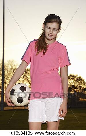 Stock Photography - Football player standing with ball. Fotosearch