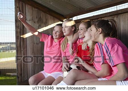 Stock Photograph - Football team taking picture together. Fotosearch