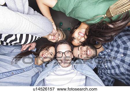 Friends smiling together in circle View Large Photo Image Stock Photo - Friends smiling together in circle. Fotosearch