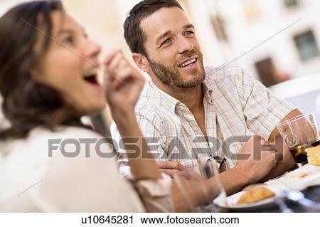 Friends talking at dinner View Large Photo Image Stock Image - Friends talking at dinner. Fotosearch
