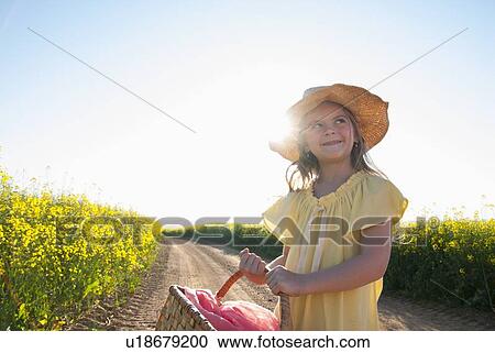 Girl carrying basket on dirt road View Large Photo Image Stock Image - Girl carrying basket on dirt road. Fotosearch