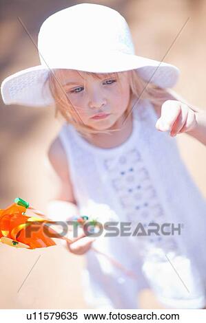 Girl holding pinwheel outdoors View Large Photo Image Stock Photography - Girl holding pinwheel outdoors. Fotosearch