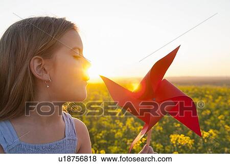 Girl playing with pinwheel outdoors View Large Photo Image Stock Photo - Girl playing with pinwheel outdoors. Fotosearch