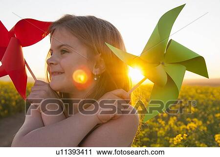 Girl playing with pinwheels outdoors View Large Photo Image Stock Image - Girl playing with pinwheels outdoors. Fotosearch