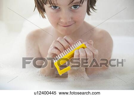 Stock Photography - Girl scrubbing her nails in bath. Fotosearch