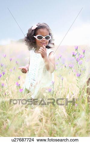 Girl standing in tall grass View Large Photo Image Picture - Girl standing in tall grass. Fotosearch