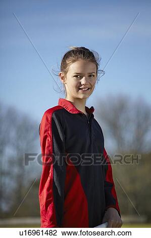 Girl standing on field View Large Photo Image Stock Image - Girl standing on field. Fotosearch