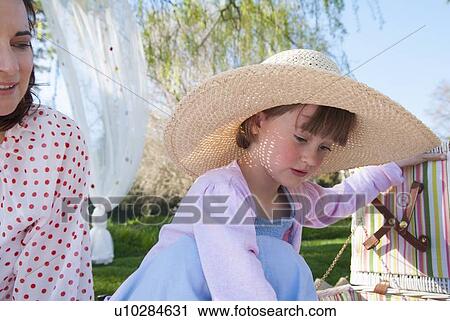 Girl unpacking picnic basket outdoors View Large Photo Image Stock Image - Girl unpacking picnic basket outdoors. Fotosearch