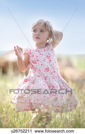 Girl walking in tall grass View Large Photo Image Stock Image - Girl walking in tall grass. Fotosearch