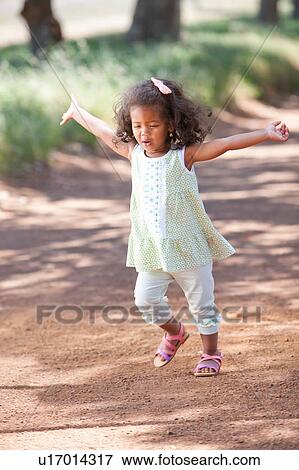 Girl walking on dirt road View Large Photo Image Stock Photo - Girl walking on dirt road. Fotosearch