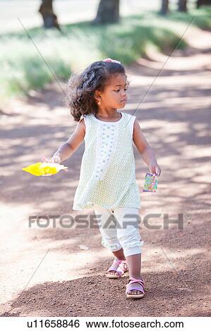 Girl walking on dirt road View Large Photo Image Stock Photograph - Girl walking on dirt road. Fotosearch