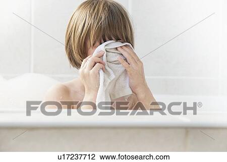Girl washing her face in bath View Large Photo Image Stock Image - Girl washing her face in bath. Fotosearch