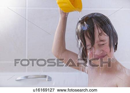 Girl washing her hair in bath View Large Photo Image Stock Photo - Girl washing her hair in bath. Fotosearch