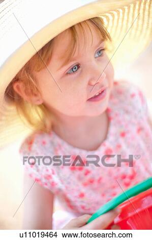 Girl wearing sun hat outdoors View Large Photo Image Picture - Girl wearing sun hat outdoors. Fotosearch