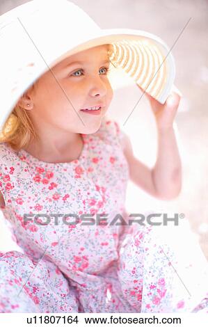 Girl wearing sun hat outdoors View Large Photo Image Picture - Girl wearing sun hat outdoors. Fotosearch